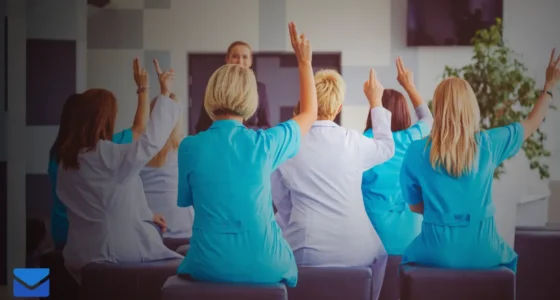 Employees raising hands during a training session.