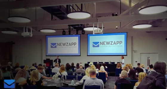 A diverse team discussing internal communications strategies in a modern office setting