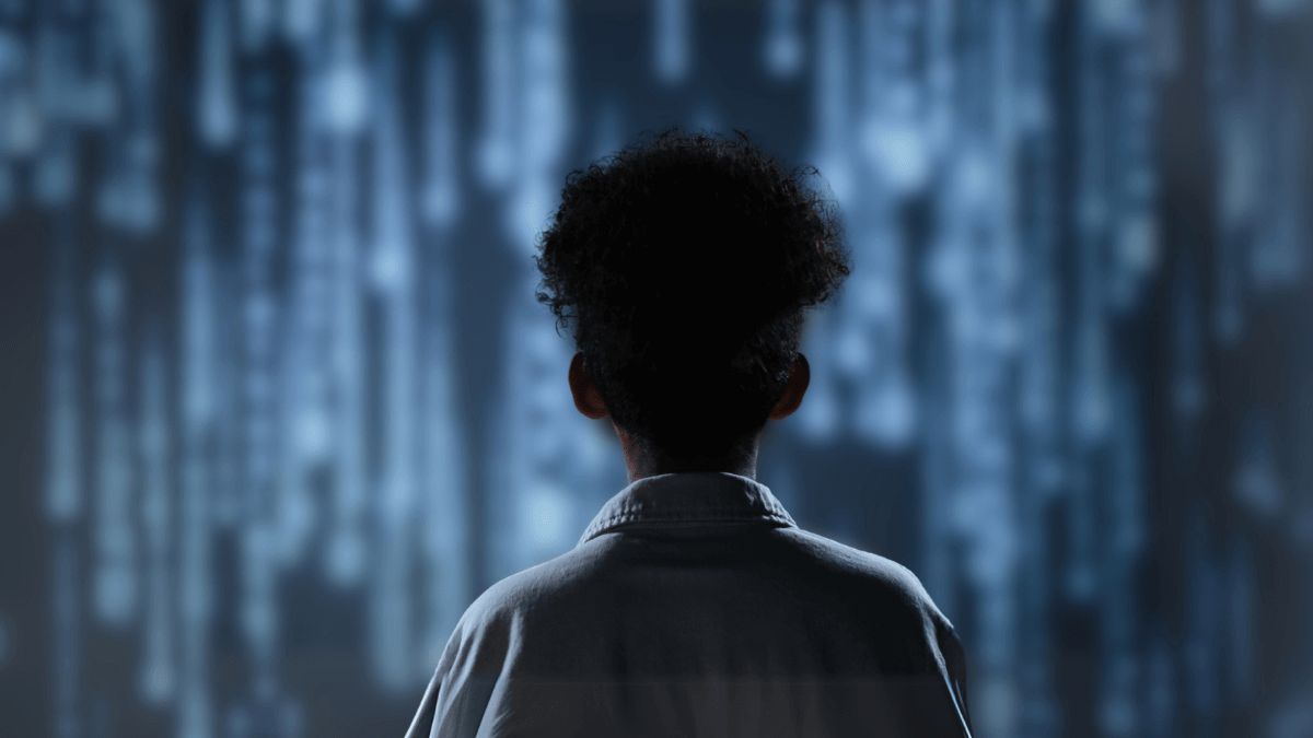 women with her back to the viewer, stood Infront of a waterfall of light